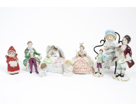 A miscellaneous collection of ceramic figures, including two Frankenthal porcelain models of young men in green coats, a furt