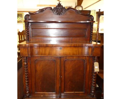 A mid-Victorian mahogany serpentine front chiffonier, having a raised superstructure and cushion frieze drawer over twin lowe