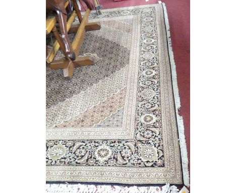 A large Persian woollen red Tabriz rug, having all over heavy floral stylised ground within trailing tramline borders, 350 x 
