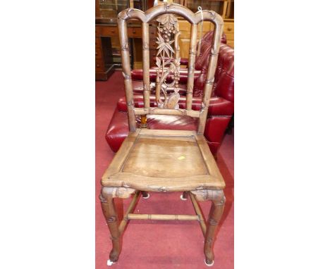 An early 20th century Chinese 'rosewood' single panelled seat hall chair, having carved floral and berry detail, w.43cmChair 