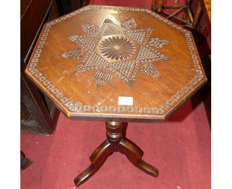 A floral geometric relief carved octagonal fixed top pedestal tripod occasional table, dia.46cm; together with a bobbin turne
