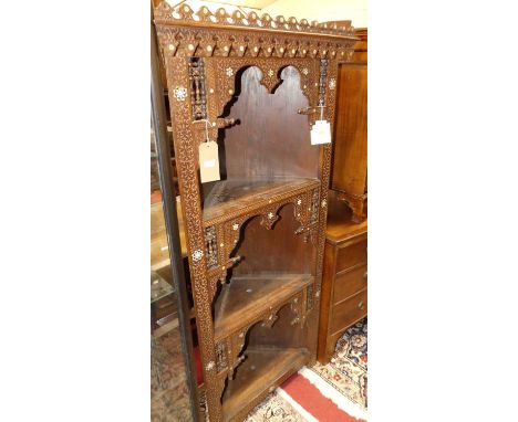 An early 20th century Syrian blind carved, stained hardwood and mother of pearl inlaid freestanding open corner cabinet, havi