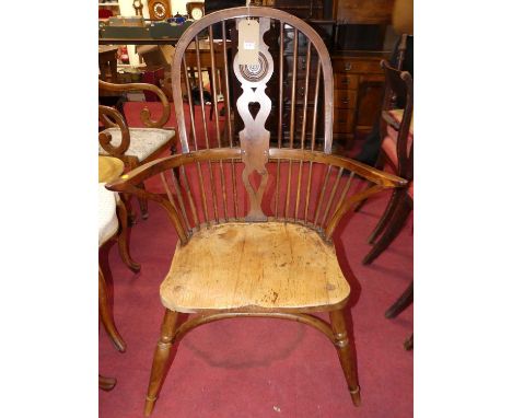 A provincial elm, yew and fruitwood splat and stick back Windsor chair, with crinoline stretcher, w.70.5cm