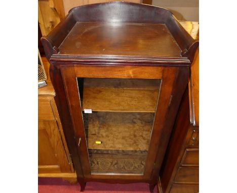 An Edwardian walnut single door glazed music cabinet, having raised three-quarter ledge detail, width 51.5cmTop inside frame 