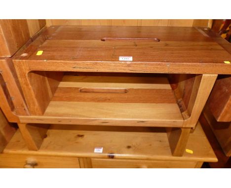 A contemporary hardwood sectional stacking bookcase, comprised of multiple sections with central cut-out carry handles and un