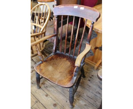 A Victorian beech and elm stick back arm chair