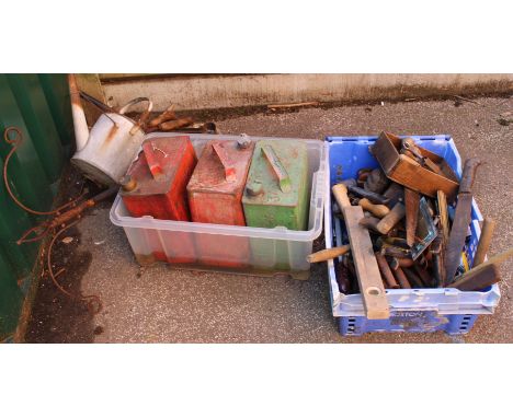 A crate of assorted tools and old petrol cans etc