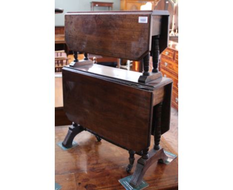 An Edwardian mahogany two tier gate leg table