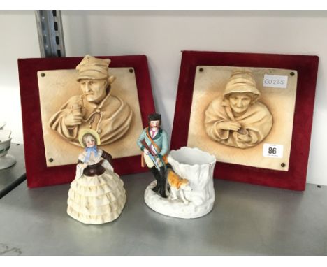 A pair of Continental Flemish style relief portrait plaques modelled as male and female peasants together with two china figu