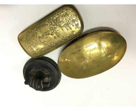 A 19th century oval Dutch brass engraved snuff box, late brass tobacco box decorated with figures and an iron fist paperweigh