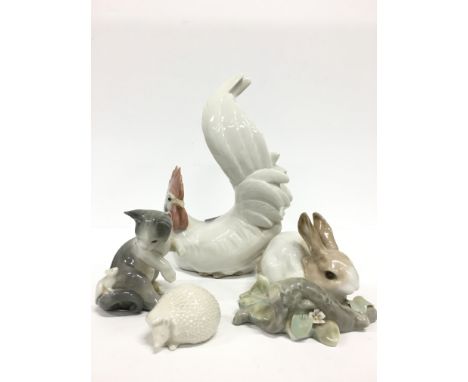 A Lladro china model of a Cockerel together with another modelled as a Rabbit (damage to leaf) together with a Kitten with a 