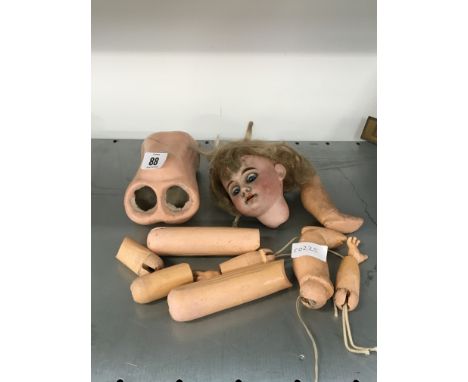 An early 20th century bisque china head doll on composition body (needs re-stringing).
