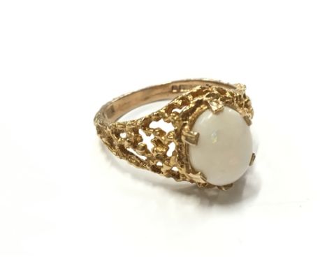 A 9 carat gold single opal set dress ring (total weight 3.8 grams).