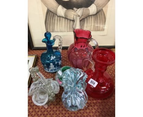 Six various glass items including a Mary Gregory blue glass carafe decorated with a Boy Playing a Flute.