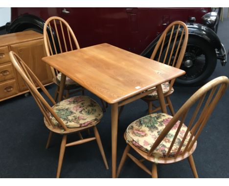 An Ercol Windsor light finish rectangular elm top table, resting on four turned beech supports with dowelled under shelf toge