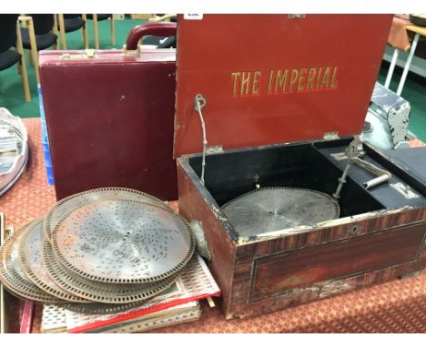 A late 19th century Imperial Polyphon style metal disc player with various metal discs.