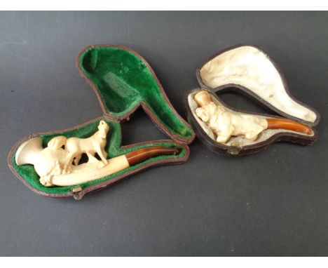 A meerschaum and amber horse pipe & meerschaum and amber seated lion pipe