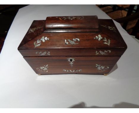 A Regency  Rosewood Tea Caddy inlaid with Mother of Pearl of Sarcophagus form.
