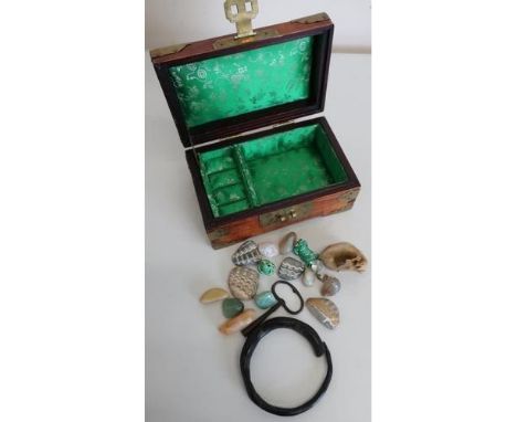 Small Chinese brass bound hardwood jewellery box containing a small quantity of polished stones, bangle bracelet etc 