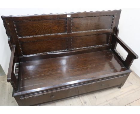Oak monks bench, with four paneled top above a single long drawer (130cm x 87cm x 50cm) 
