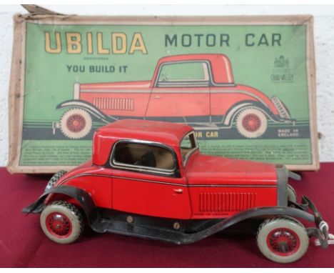 A Ubilda tin plate clockwork motorcar by Chad Valley (25cm), with spanner and two spare nuts and bolts, in original box 