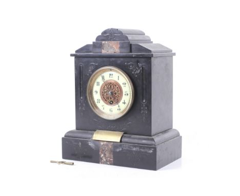 A Victorian black slate mantel clock. Carved and inlaid decoration to the case. Pierced copper work centre of the dial. Brass