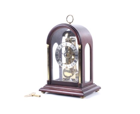 A 20th century Franz Hermle German skeleton mantel clock. With a four glass mahogany case. Striking to a bell, S/N 791-081. K