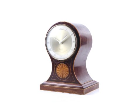 A late 18th century Sheraton mantel clock. The large mahogany balloon case with satinwood inlay. Later converted with an elec
