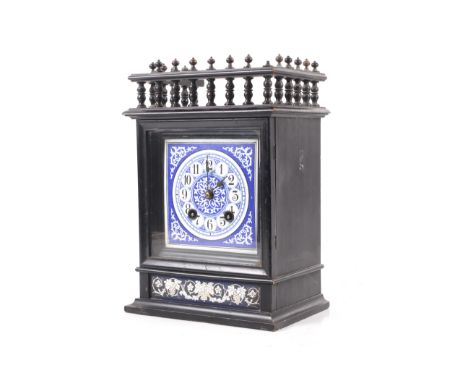A Victorian 'Aesthetic' 8 day chiming mantel clock. With a square blue and white enamel dial, Arabic numerals. Striking to a 