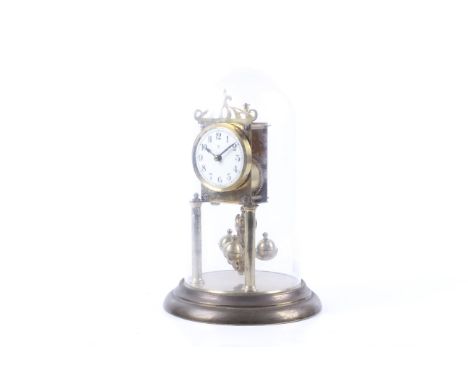 A 20th century Baden 400 day anniversary torsion mantel clock. Made in Germany. Under a plastic dome. H29cm
