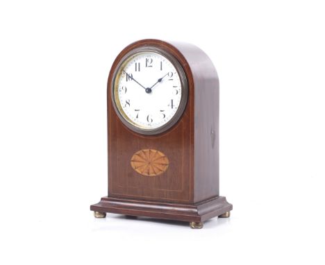 An Edwardian arch shaped inlaid mahogany mantel clock. Buren Swiss made, 8 day movement. Solid case inlaid with satinwood fan