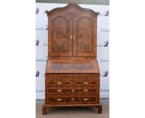 19th century walnut bureau cabinet, the top with two panelled doors enclosing cupboard, pigeon holes and drawers, fall front 