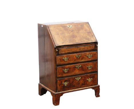 George II walnut bureau, fall flap enclosing well, cupboards, drawers and pigeon holes, over three long graduated drawers and