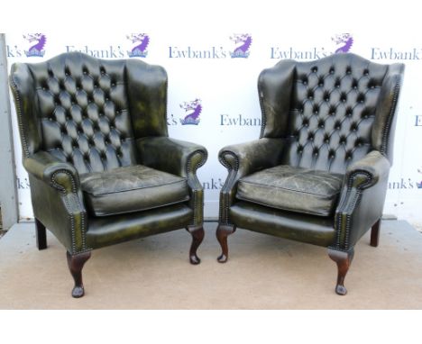 Set of three leather button back wing arm chairs raised on mahogany cabriole legs.     .     