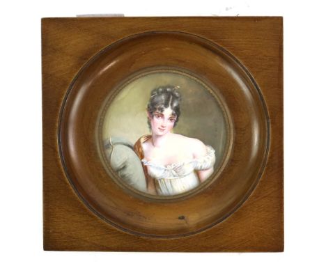 19th century circular portrait miniature depicting a young woman in a white dress leaning on a cushion, in a wooden frame, 6.