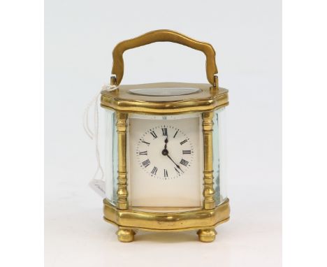 Brass and glass serpentine miniature carriage clock with lever movement 12cm.     .     