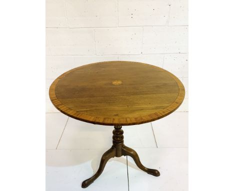 Mahogany circular tilt top table on reeded pedestal to three pad feet, 87 x 77cms. Estimate £30-40.