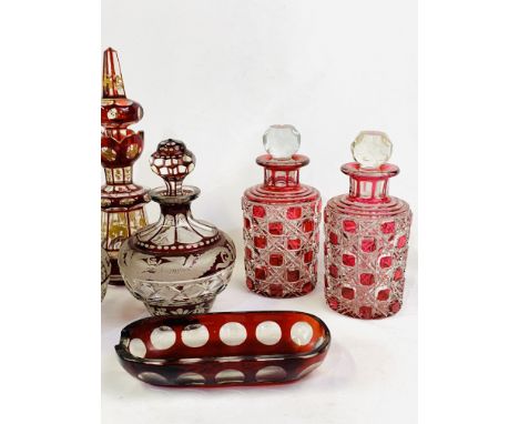 A pair of French ruby cut and etched to clear glass scent bottles, 15cms high; a pair of French cranberry cut to clear glass 