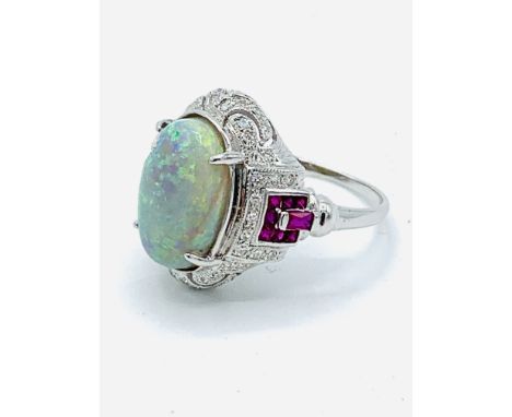 18ct white gold opal set ring with rubies and diamonds to shoulders, size N, opal 13.5 x 9.5 mms white with blue and green sh