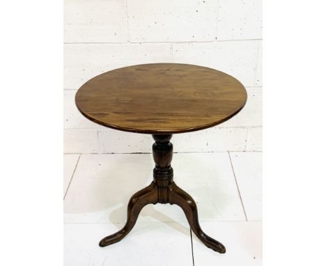 Circular mahogany table on turned pedestal to three pad feet, 69 x 72cms. Estimate £20-40.