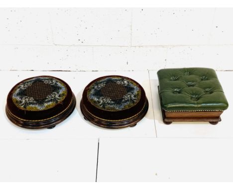 Two circular mahogany and tapestry top foot stools, diameter 37 x 12cms; together with a mahogany green buttoned leather upho