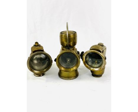 Three carbide vehicle lamps: Lucas 626 'King of the Road'; Lucas brass cased lamp marked "Calcia Club"; P &amp; H Limited whi