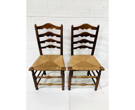 Two oak framed ladder back chairs with string seats, 51 x 40 x 96cms. Estimate £40-100.