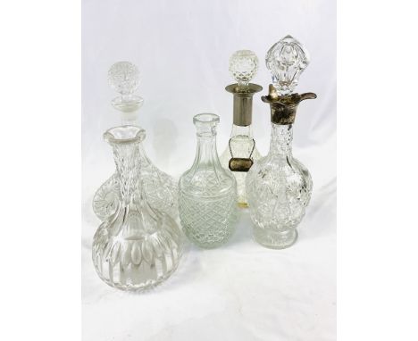 Five various cut glass decanters, one with hallmarked silver neck, the other with silver plate neck and label, two are ships 