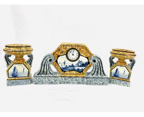 Continental porcelain mantel clock and garnitures in two colour marble effect, with Delft style panels, 38 x 21cms. Estimate 