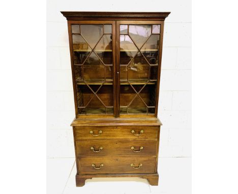 19th Century mahogany glazed bookcase, over three graduated drawers on bracket feet, 96 x 42 x 184cms. Estimate £100-150.