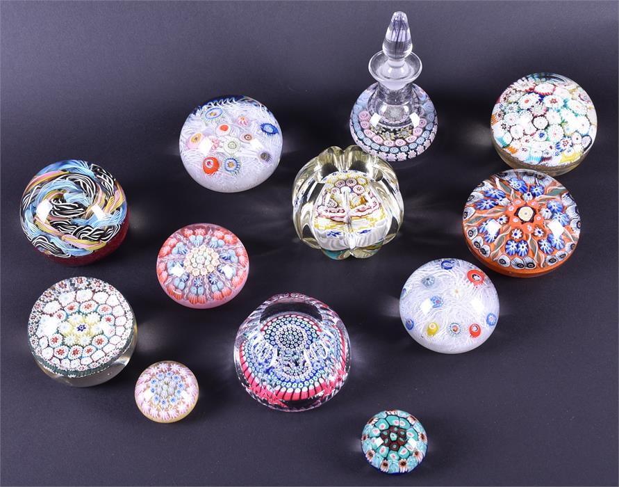 A collection of twelve assorted glass paperweights brightly coloured