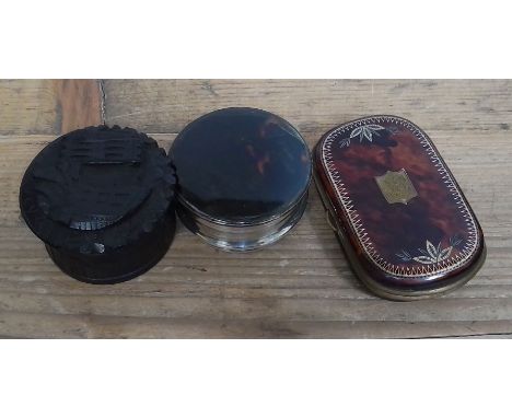 An Irish bog oak snuff box, a pique inlaid tortoiseshell purse and a white metal and tortoiseshell box.  