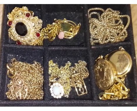 A quantity of yellow metal jewellery including an opal pendant, two lockest, chains and pendants.  