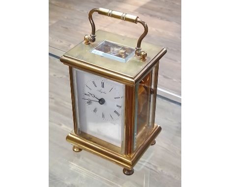 A brass carriage clock, the dial signed 'Angelus'.  